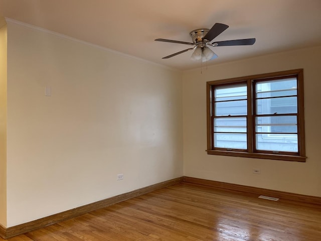 empty room featuring light hardwood / wood-style floors, ceiling fan, and ornamental molding