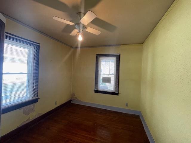 spare room featuring ceiling fan, crown molding, and dark hardwood / wood-style floors