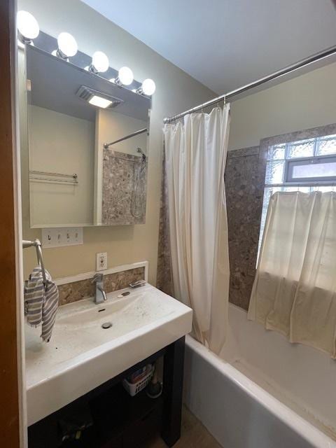 bathroom featuring vanity and shower / tub combo