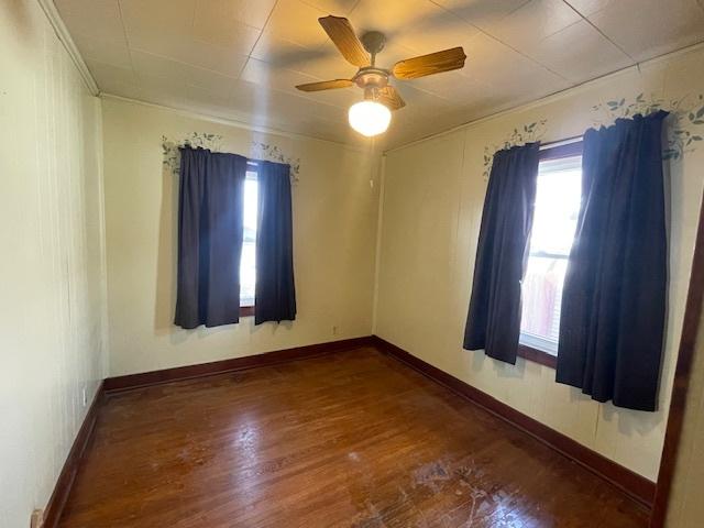 empty room featuring ceiling fan and wood-type flooring