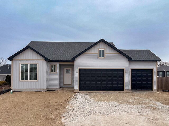 view of front of home featuring a garage, a front lawn, and cooling unit