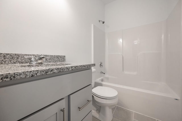 full bathroom featuring vanity, toilet,  shower combination, and tile patterned floors