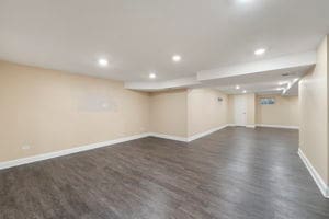 basement with dark hardwood / wood-style floors