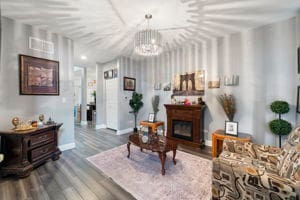 living room featuring wood-type flooring and an inviting chandelier