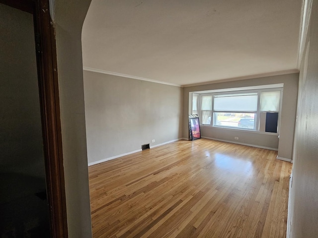 unfurnished room with light hardwood / wood-style flooring and ornamental molding