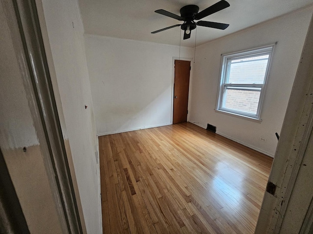 unfurnished room featuring ceiling fan and light wood-type flooring