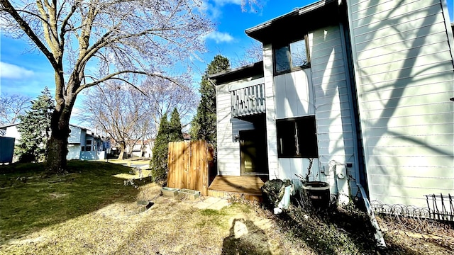 view of side of property with a yard and central AC unit