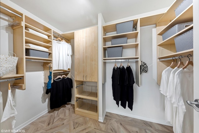 walk in closet featuring light parquet flooring