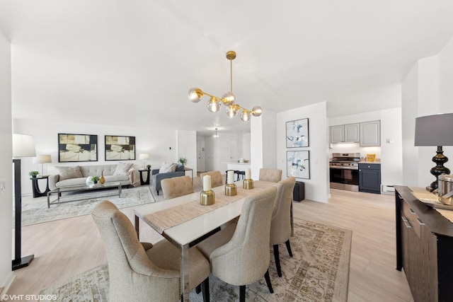 dining room with a chandelier and light hardwood / wood-style flooring