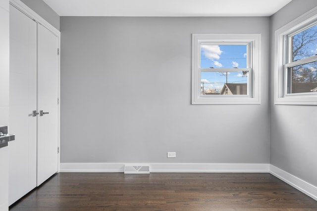 unfurnished room featuring dark hardwood / wood-style floors