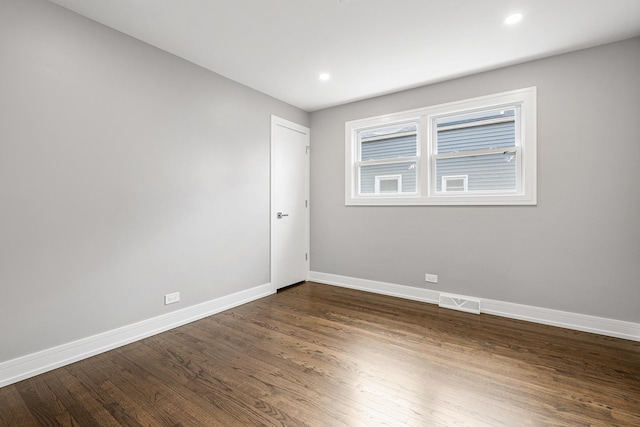 spare room featuring dark hardwood / wood-style flooring