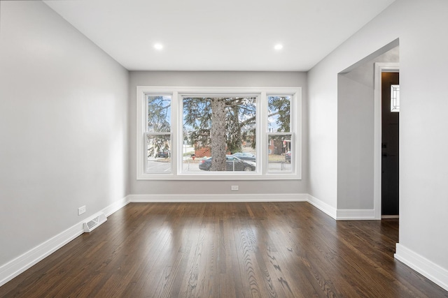 empty room featuring dark hardwood / wood-style flooring