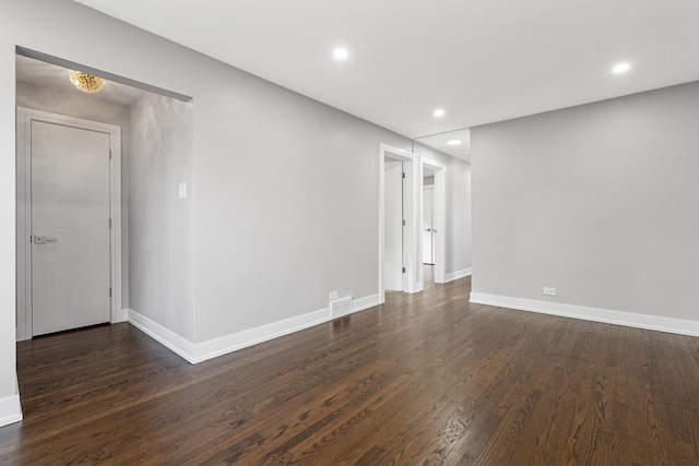 spare room featuring dark hardwood / wood-style floors