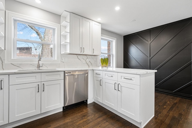 kitchen featuring dishwasher, dark wood-type flooring, white cabinets, sink, and kitchen peninsula