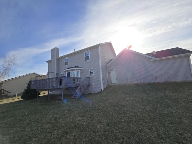 rear view of property with a yard and a deck