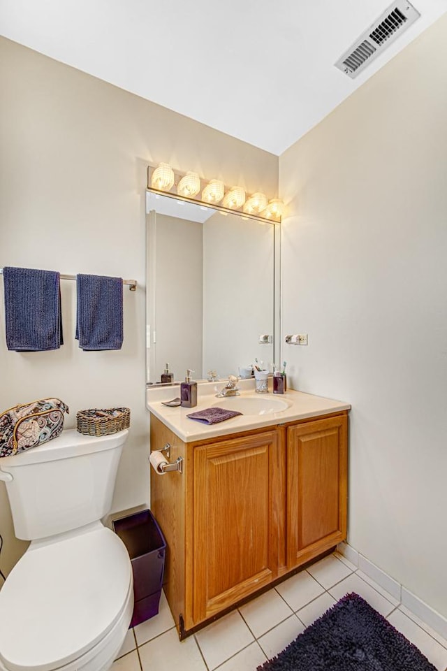 bathroom with tile patterned floors, vanity, and toilet