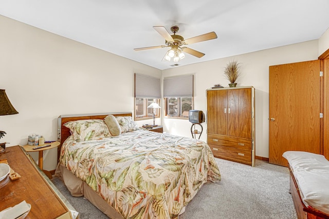 bedroom featuring light carpet and ceiling fan