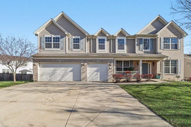 view of front of home featuring a front lawn, a porch, and a garage