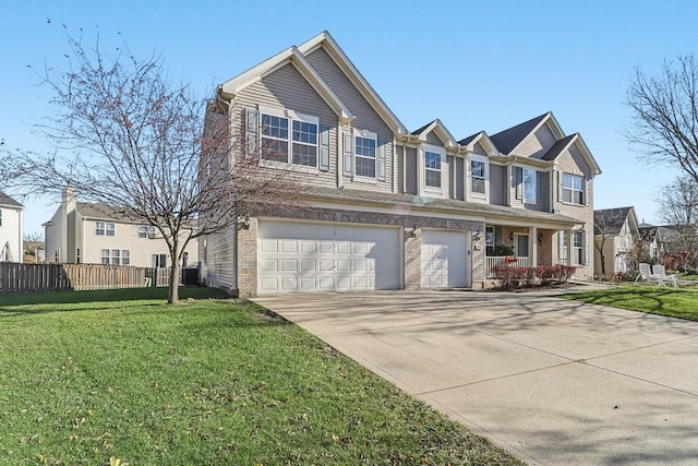 view of front of property with a garage, a front yard, and central AC