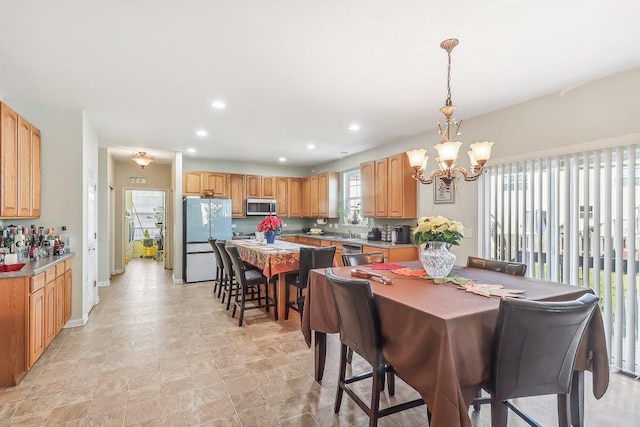 dining room featuring sink and an inviting chandelier