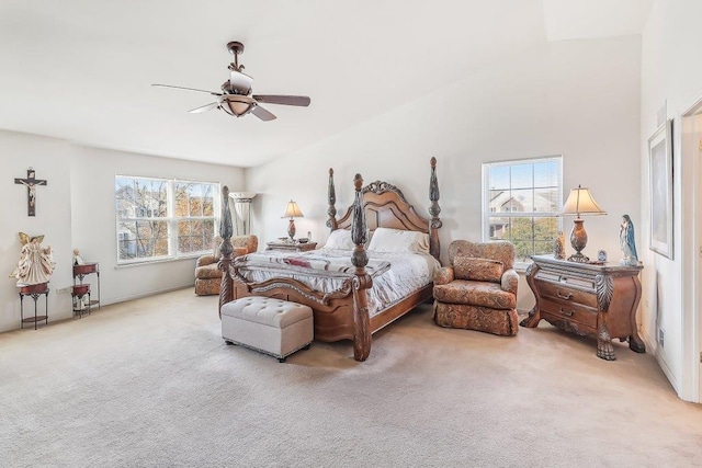 bedroom with ceiling fan, carpet floors, and vaulted ceiling