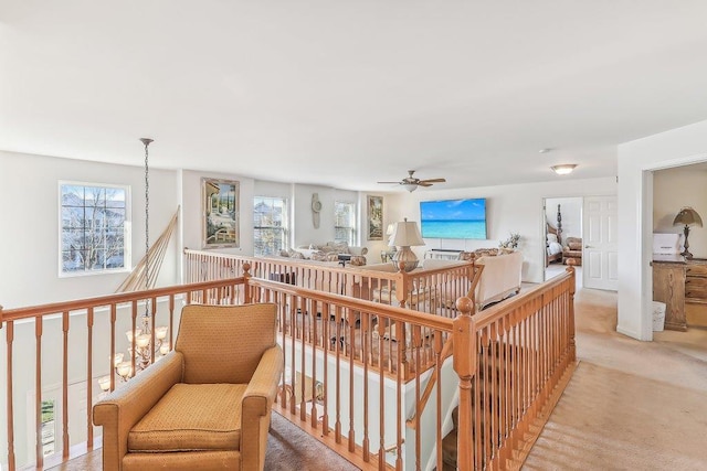 interior space with ceiling fan and light carpet