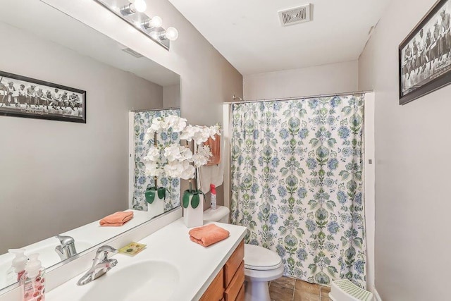 bathroom featuring tile patterned floors, vanity, and toilet