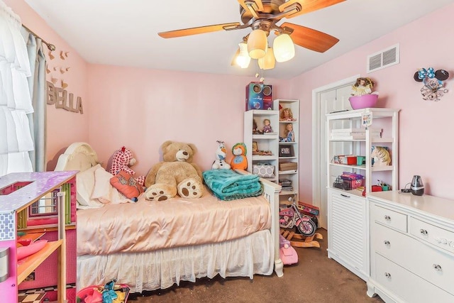 bedroom with ceiling fan and dark colored carpet