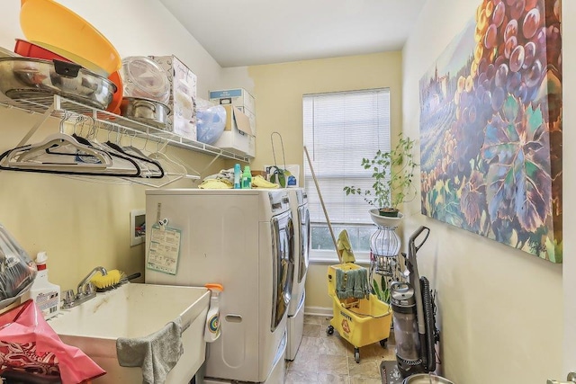 laundry room with separate washer and dryer and sink