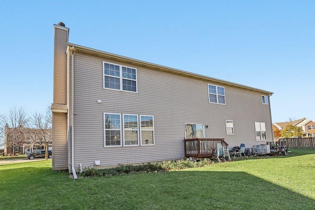 rear view of house with a yard