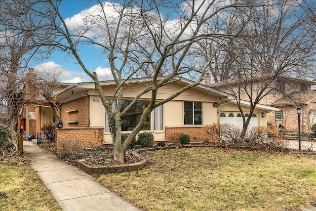 view of front facade with a front yard and a garage