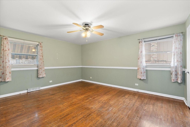 empty room with hardwood / wood-style floors and ceiling fan