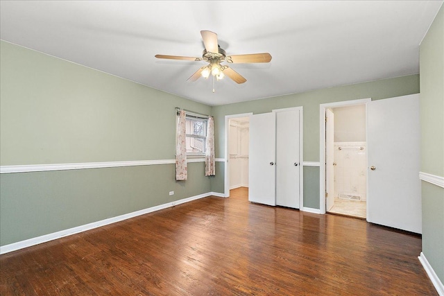 unfurnished bedroom with connected bathroom, ceiling fan, and dark hardwood / wood-style floors