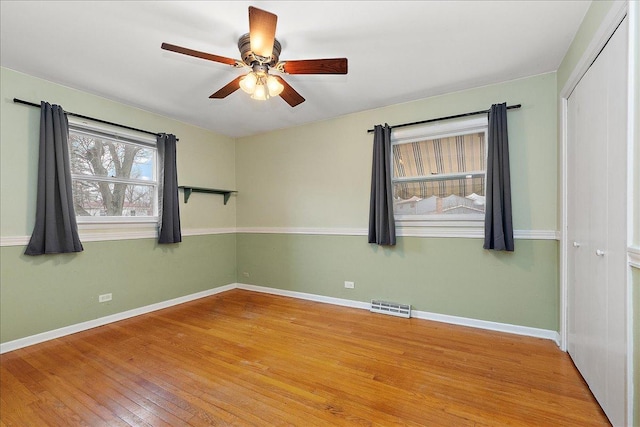 spare room with ceiling fan and light hardwood / wood-style floors