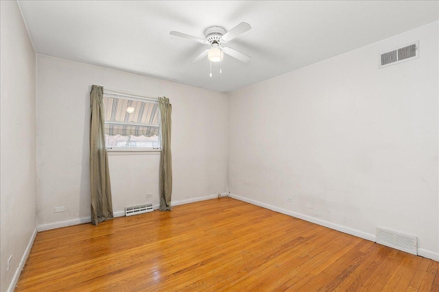 unfurnished room with light wood-type flooring and ceiling fan