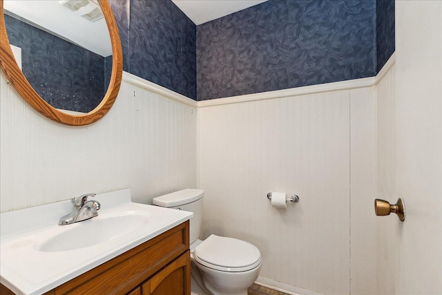 bathroom featuring vanity and toilet