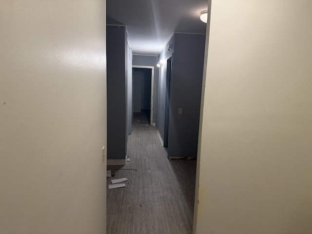 corridor with dark hardwood / wood-style flooring