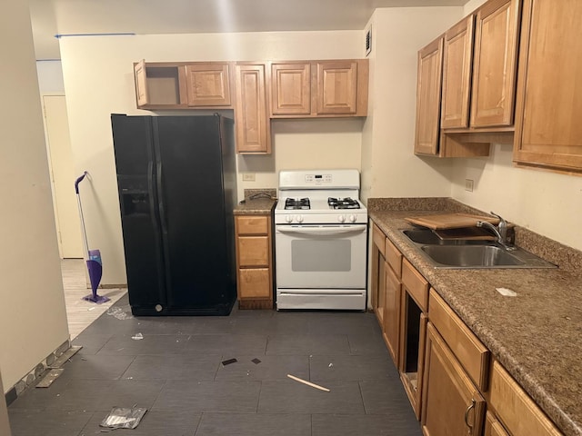 kitchen with sink, black refrigerator with ice dispenser, and white gas stove