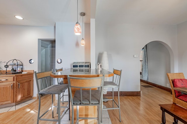 dining space with light hardwood / wood-style floors