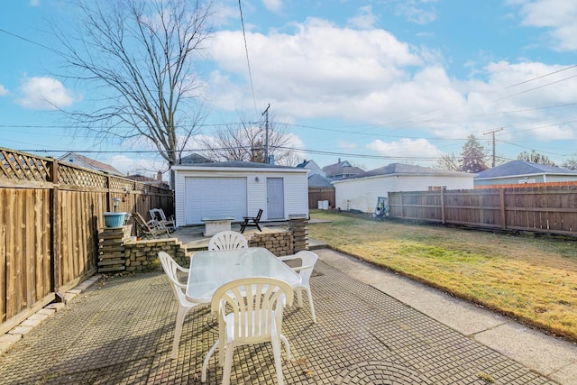 view of patio / terrace featuring a garage and an outbuilding