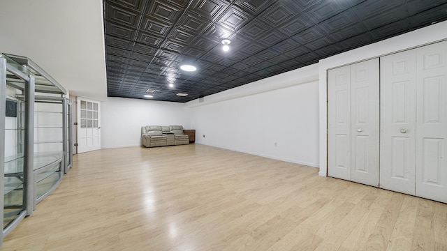 basement with light hardwood / wood-style floors