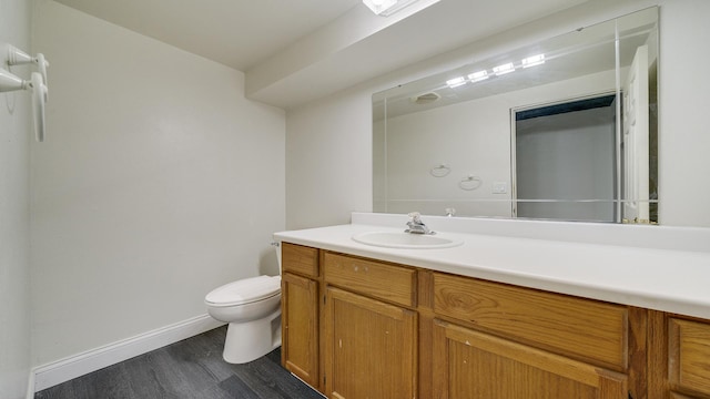 bathroom featuring hardwood / wood-style floors, vanity, and toilet