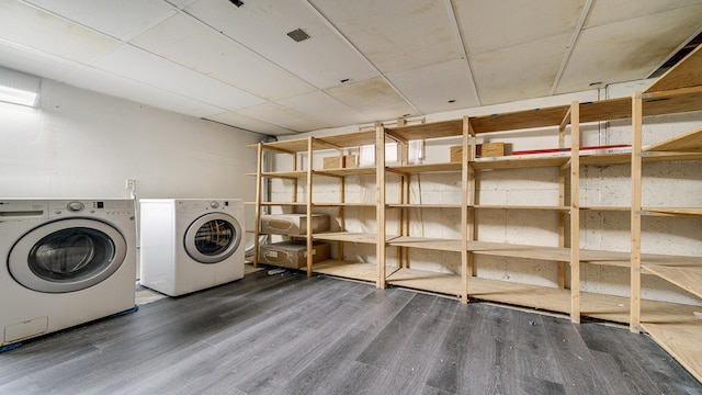 laundry area featuring dark wood-type flooring and washing machine and clothes dryer