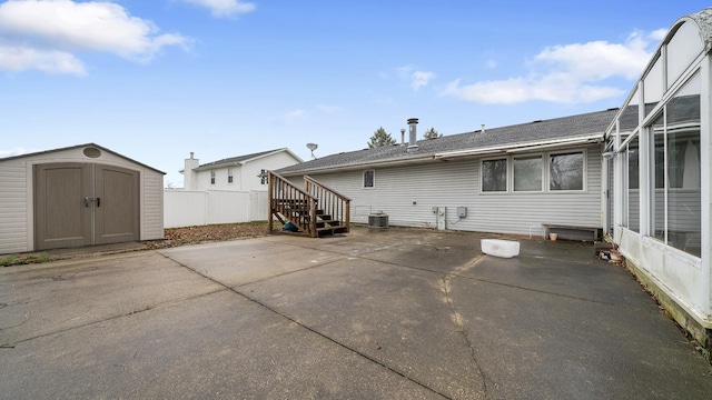 rear view of property with a patio area, central AC unit, and a storage shed