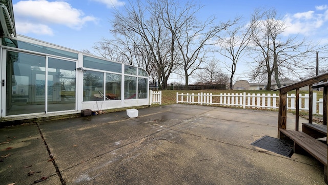 view of patio featuring a sunroom