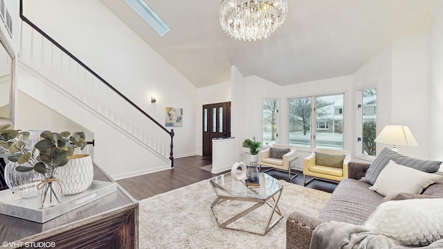 living room featuring vaulted ceiling with skylight, dark hardwood / wood-style flooring, and a chandelier