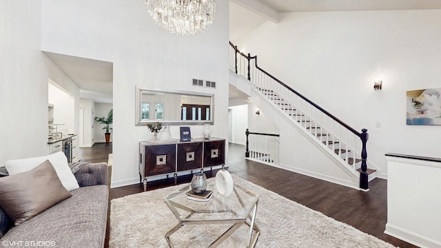 living room with beam ceiling, dark hardwood / wood-style flooring, high vaulted ceiling, and a notable chandelier