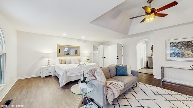 bedroom featuring ceiling fan, lofted ceiling, and light hardwood / wood-style flooring