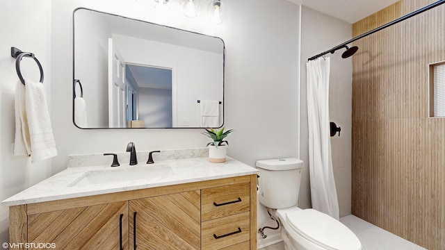 bathroom with toilet, vanity, and a shower with shower curtain