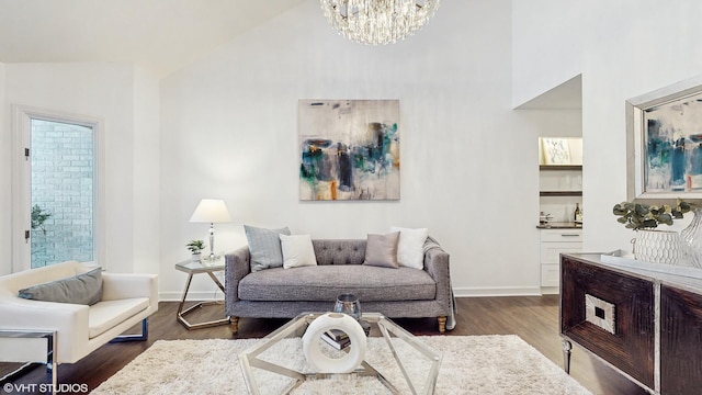 living room featuring a chandelier, dark hardwood / wood-style flooring, and vaulted ceiling